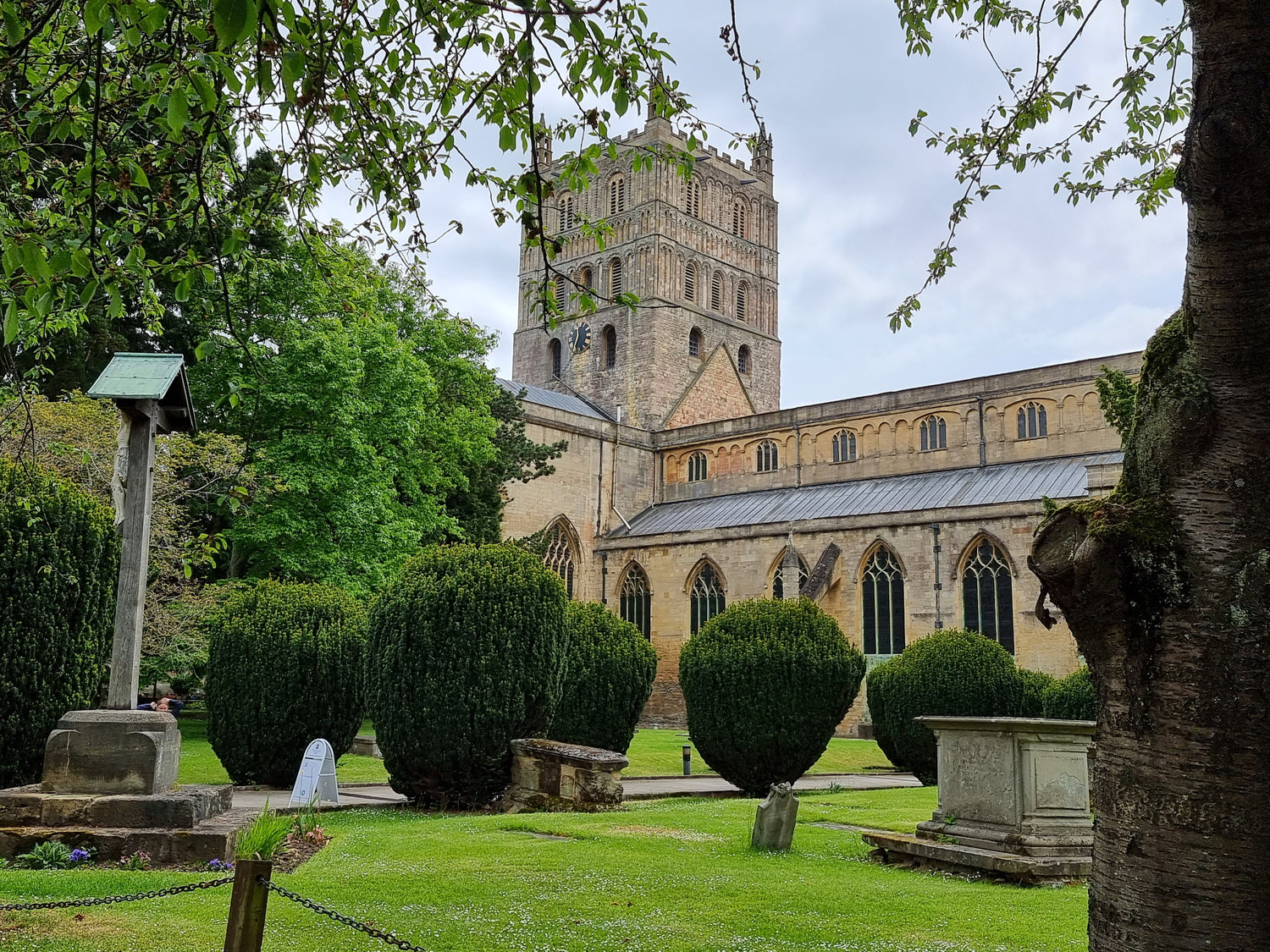 Tewkesbury abbey, with graves and bushes in foreground