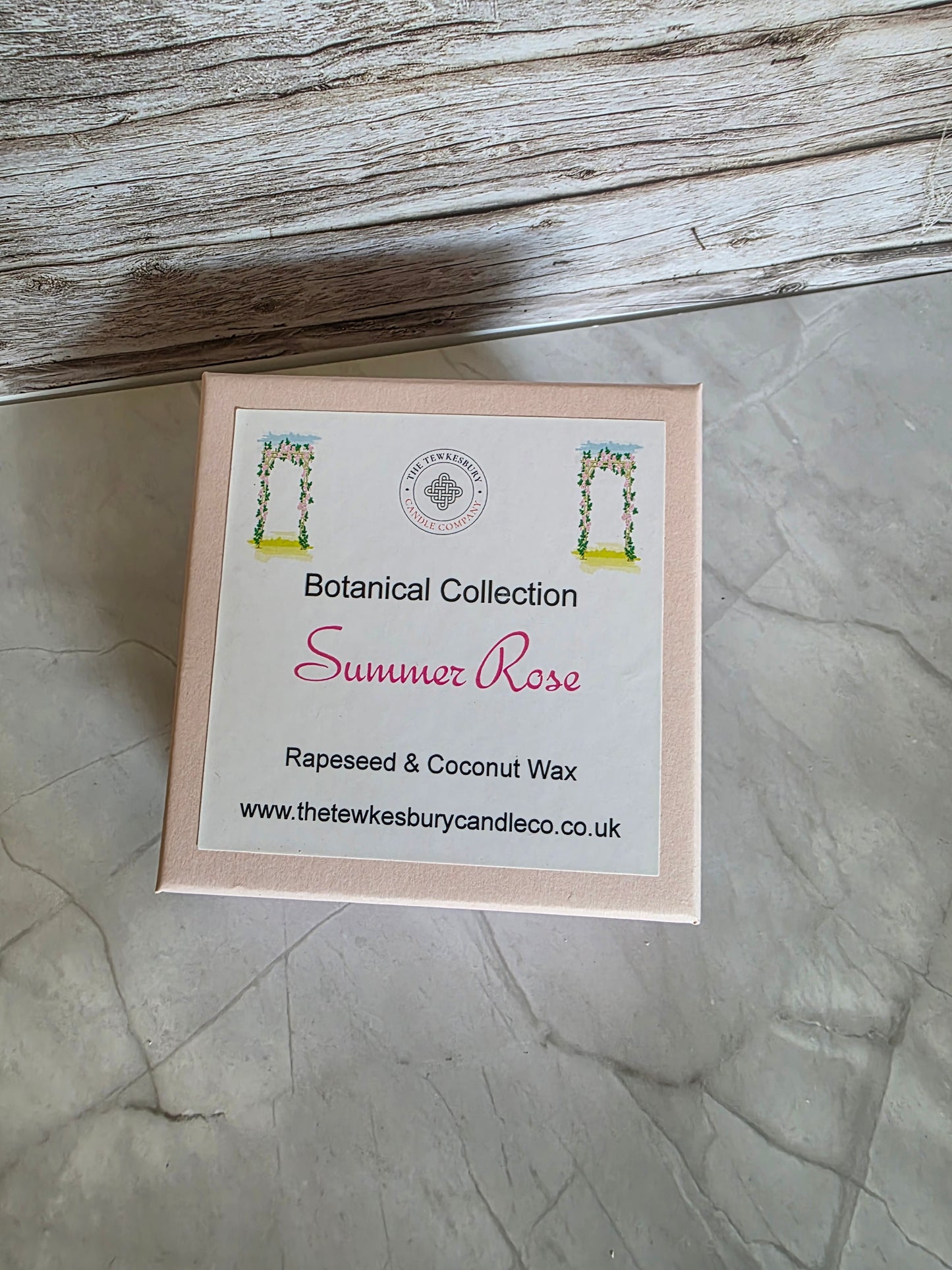 Box of wax melts with a label on a textured surface