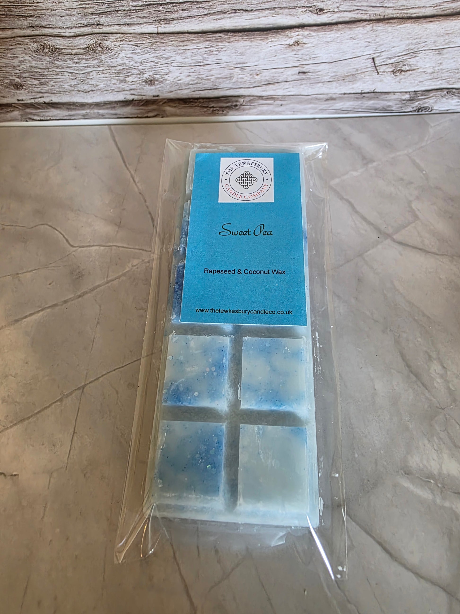Packaged product with blue and clear blocks on a wooden surface