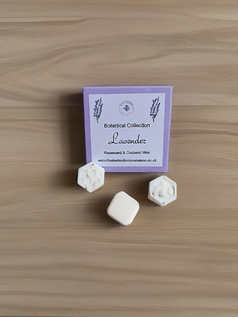 Lavender Botanical wax melts with a purple label on a wooden surface