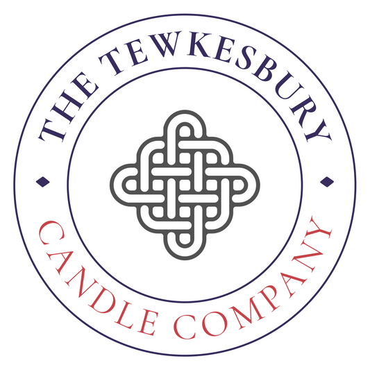 Logo of The Tewkesbury Candle Company featuring a decorative knot design within a circular border.